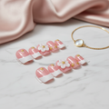 Beautiful pink press-on nails with floral design in elegant setting